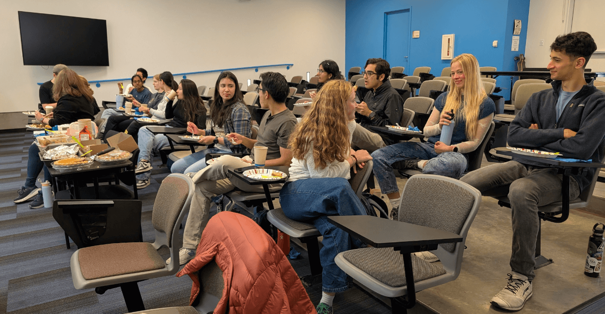 The group gathered together watching a movie and eating good food.