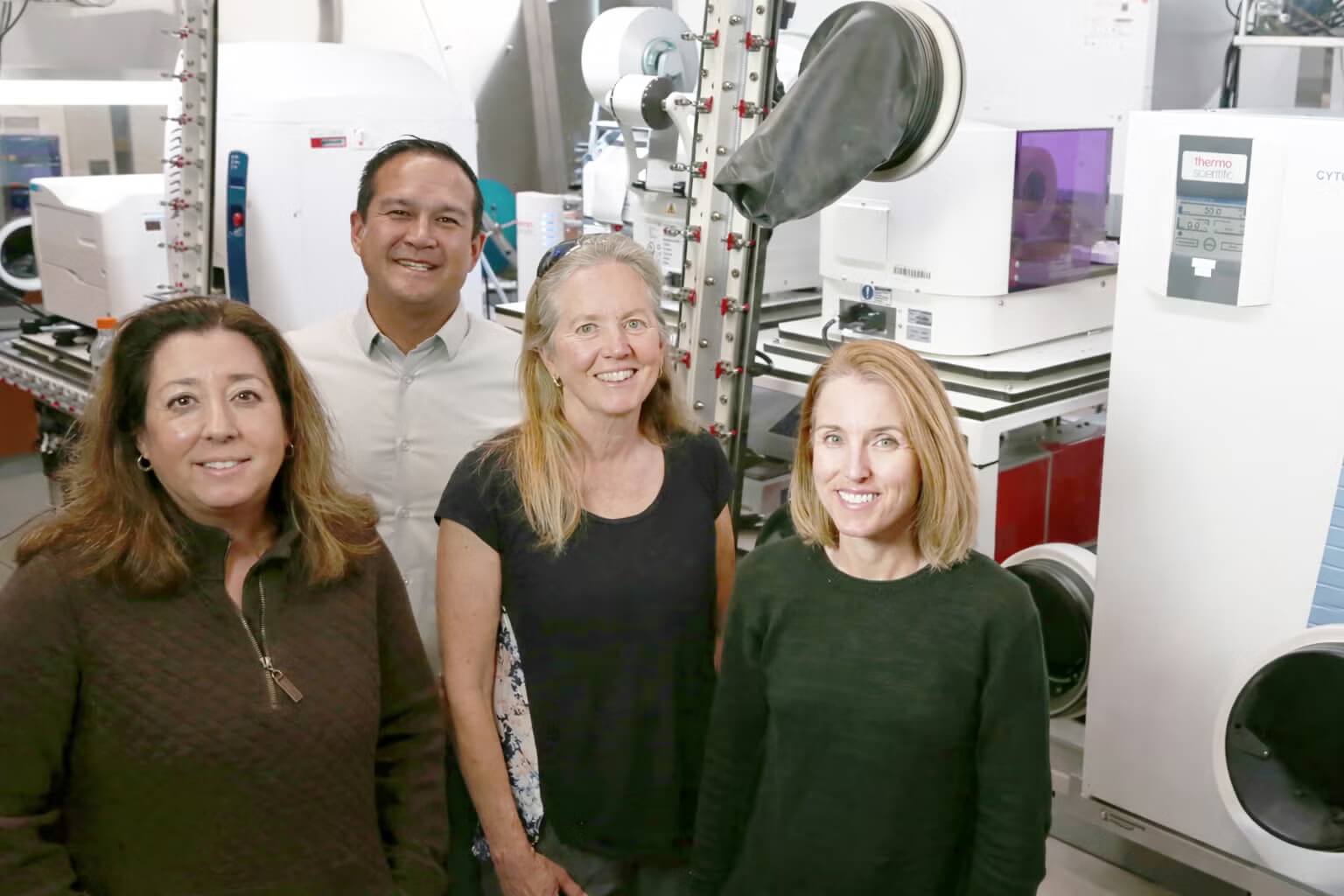 Photo of some scientists in from of the ExFAB anaerobic chamber